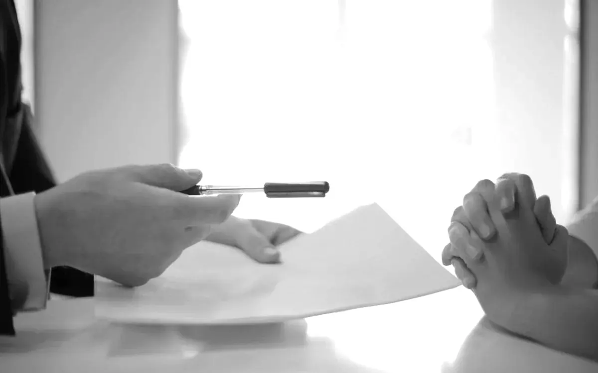 Business owners exchanging documents across a table