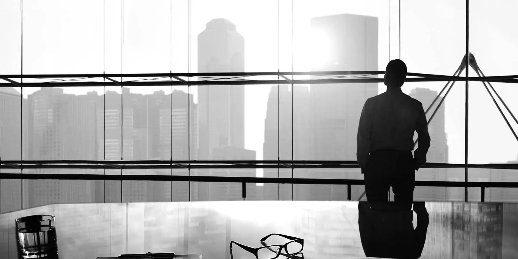Executive overlooking the city from a boardroom