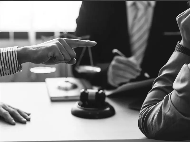 Business owners reviewing a disputed agreement with counsel